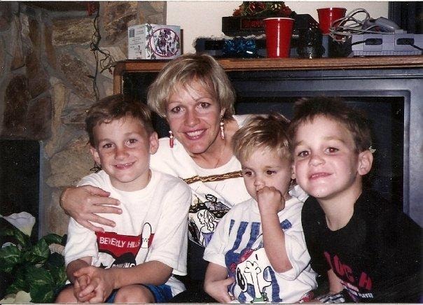 Denise M. Zettel with her three boys by the fireplace