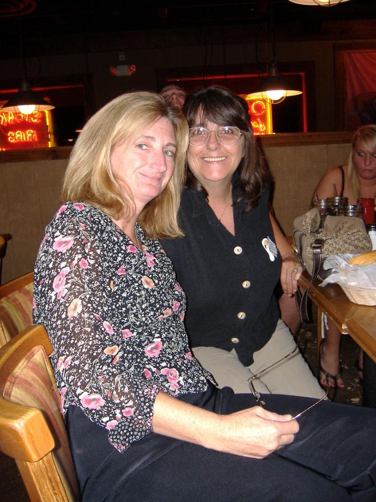 Two women smiling at restaurant