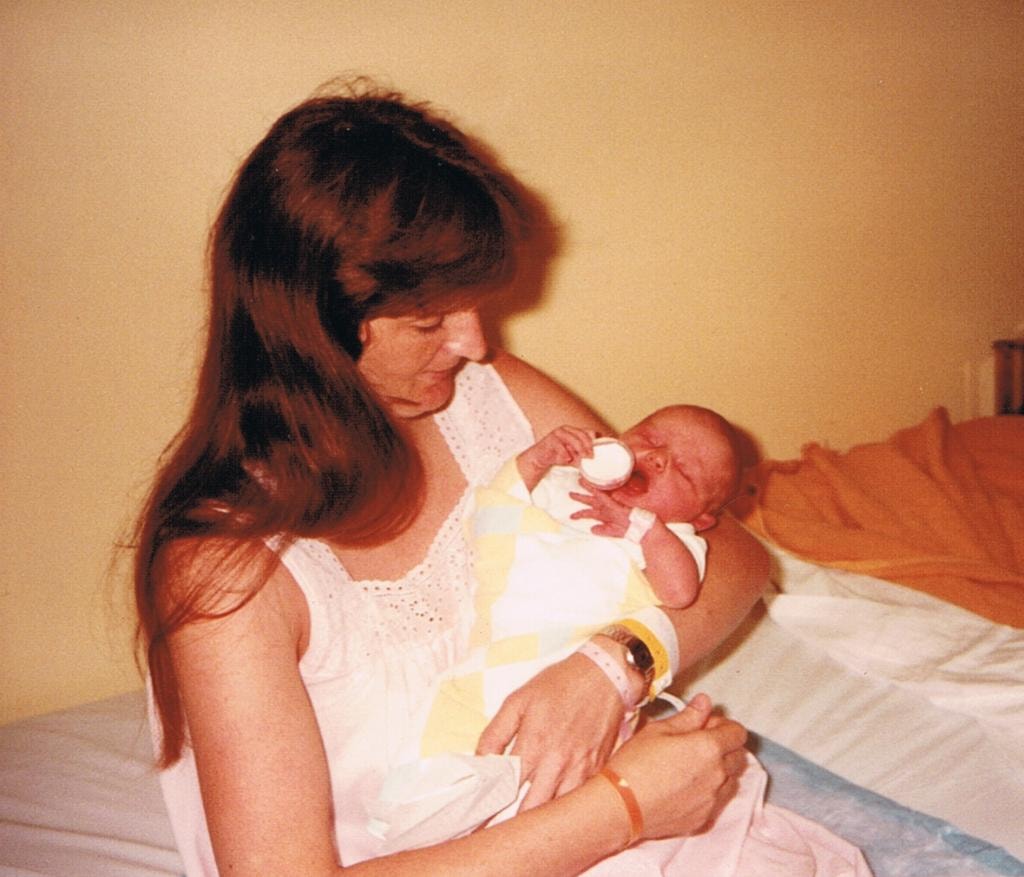 Woman holding newborn in hospital