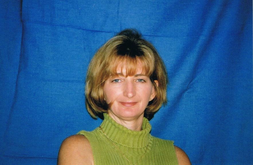 Woman portrait blue background green turtleneck