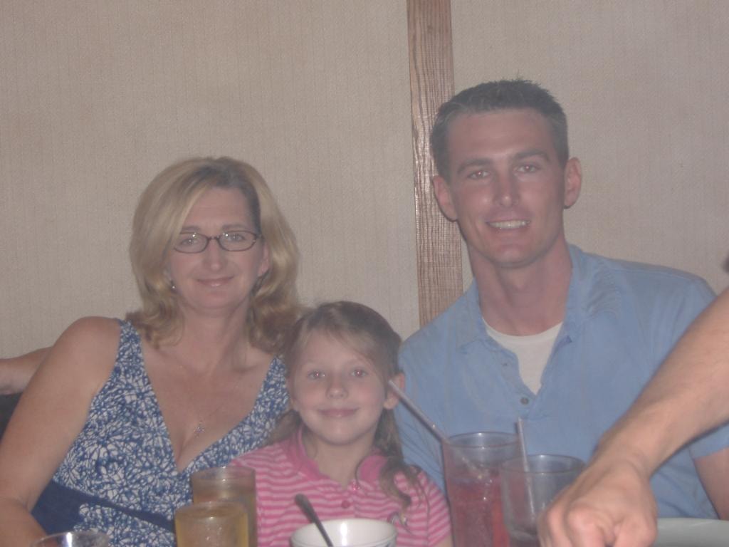 Woman man and girl at restaurant table