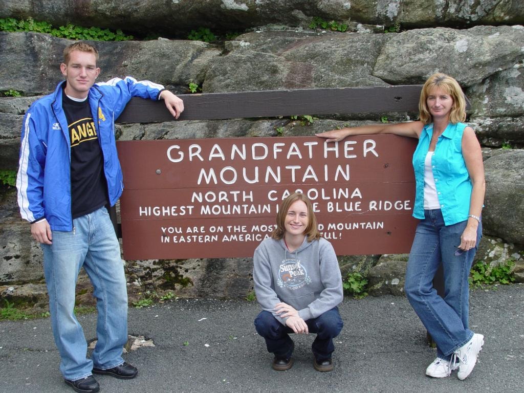 Three people outdoors on bridge at Grandfather Mountain