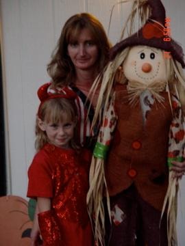 Woman and child with scarecrow decoration