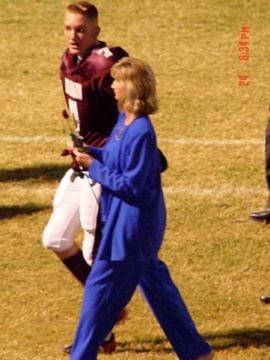 Two people at football game on field