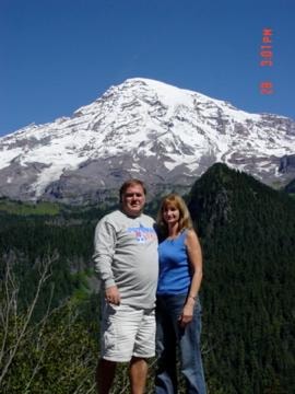 Couple posing in front of snow-capped Mount Rainier