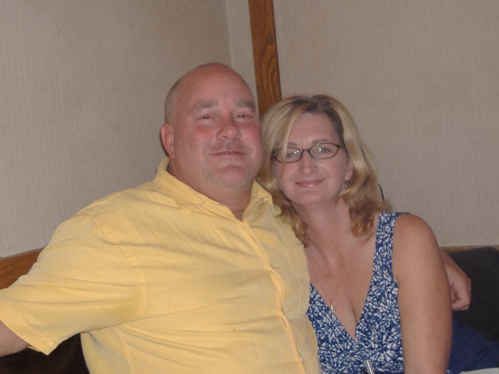 Couple posing together indoors man in yellow shirt