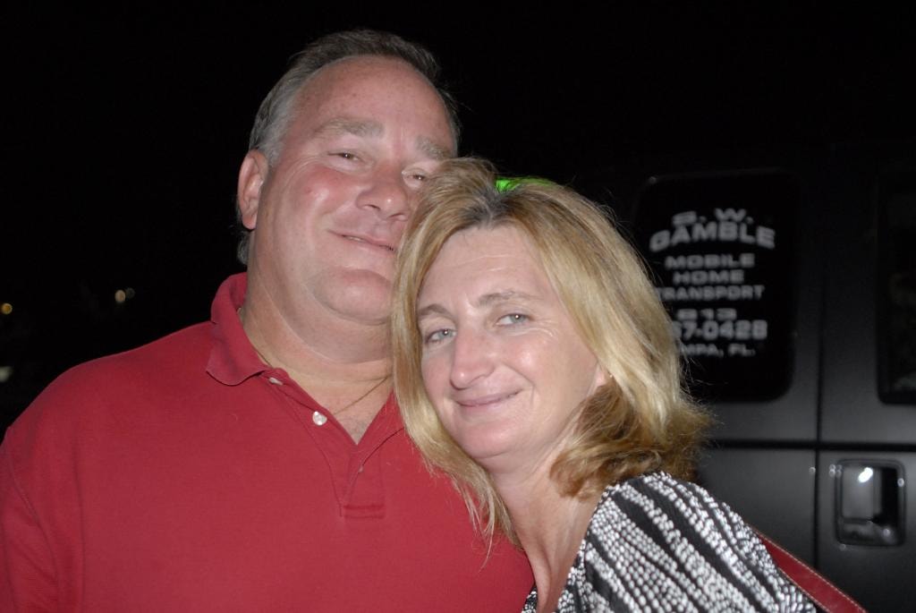 Couple smiling together outdoors at night