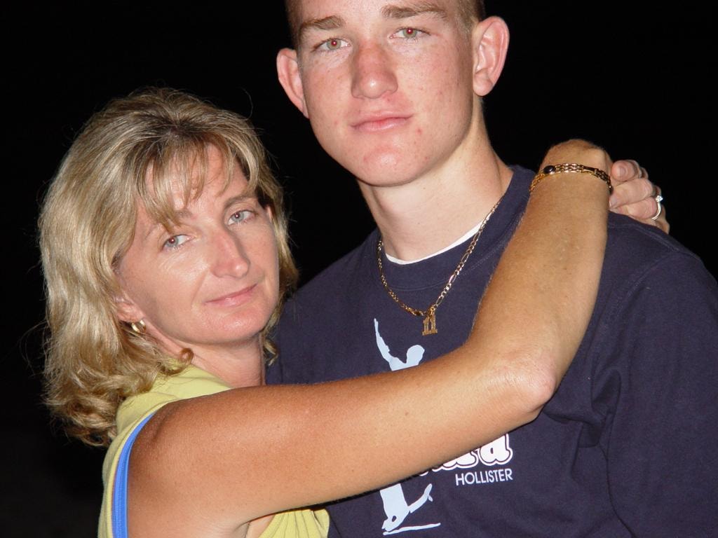 Woman with young man at night