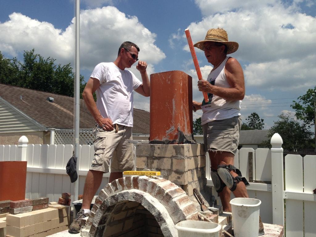 David Zettel building a brick chimney
