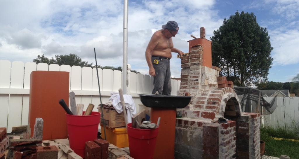 David Zettel working on a brick outdoor structure