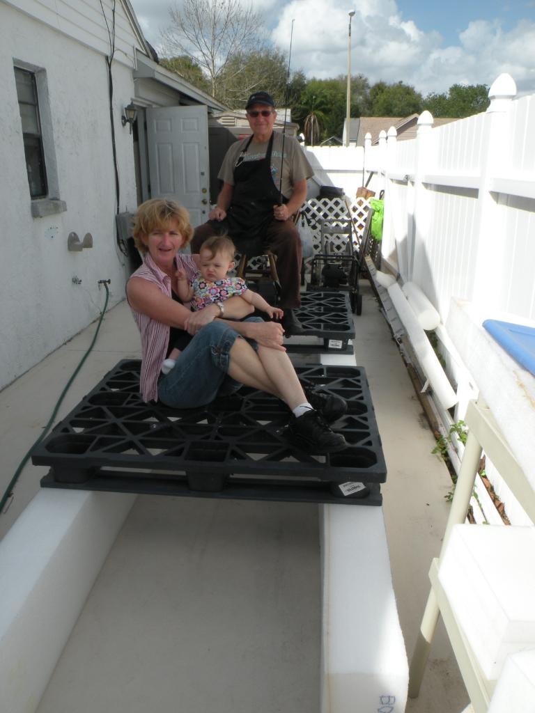 Family sitting on the foam boat project outdoors